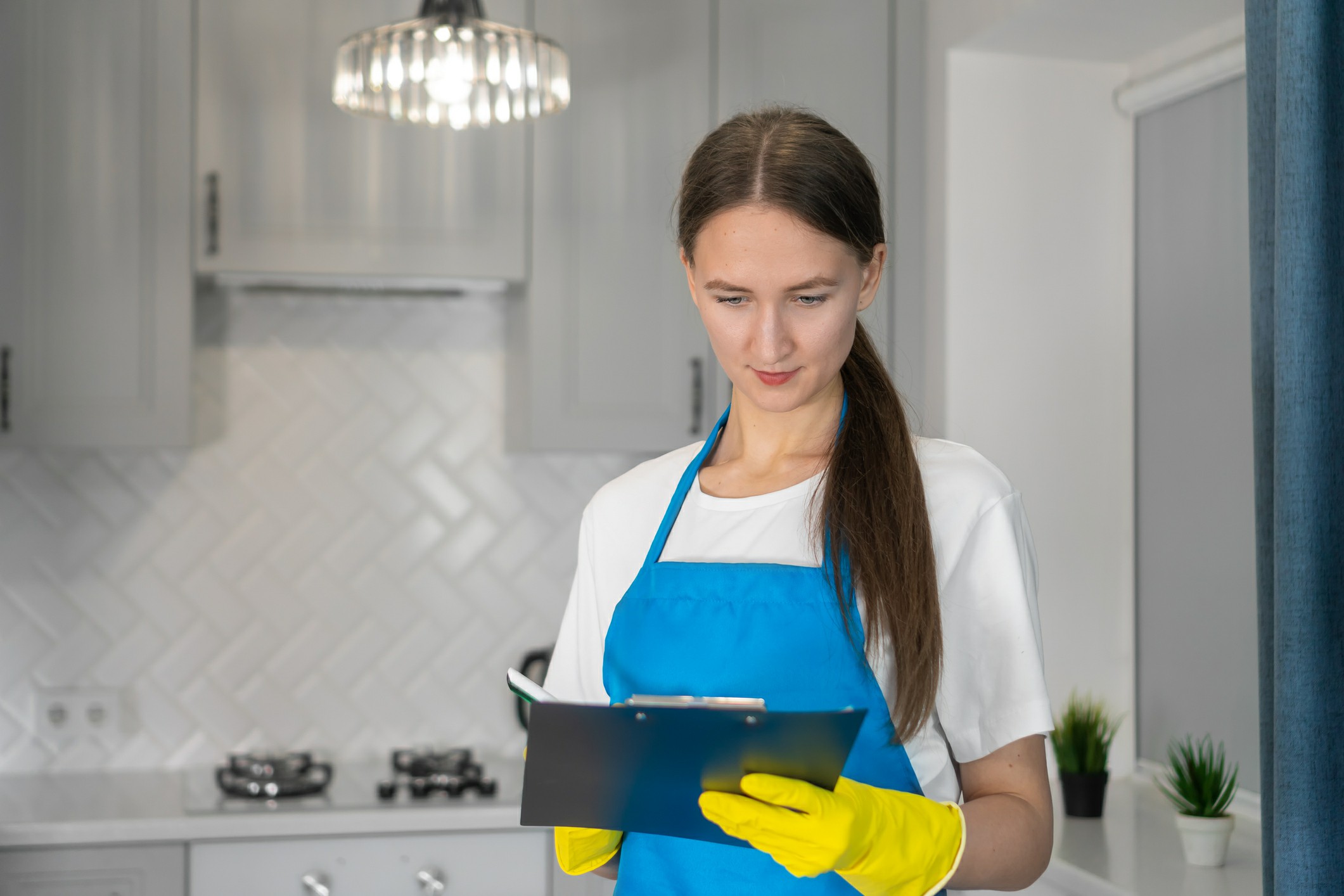 Woman creating cleaning checklist before move